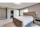 Cozy bedroom with a wood bed frame, carpeted floors, and a stacked washer/dryer in closet at 7525 N Meridian St, Indianapolis, IN 46260
