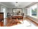 Formal dining room featuring hardwood floors, a large mirror, and plenty of seating at 7525 N Meridian St, Indianapolis, IN 46260