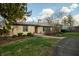 Charming home with stone exterior, a metal roof, and a curved walkway leading to the entrance at 7525 N Meridian St, Indianapolis, IN 46260