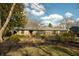 Traditional home with a stone exterior, lush green lawn and an asphalt driveway at 7525 N Meridian St, Indianapolis, IN 46260