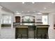 Stylish kitchen with a granite island, brick accents, and seating for casual dining at 7525 N Meridian St, Indianapolis, IN 46260