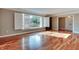 Sun-filled living room with hardwood floors, large window, and white shutters at 7525 N Meridian St, Indianapolis, IN 46260