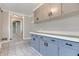 Mudroom features tiled floors, gray cabinets, and modern hardware at 7525 N Meridian St, Indianapolis, IN 46260