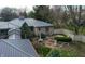 A cozy rear patio features stone pavers, tasteful furniture, and manicured landscaping, perfect for outdoor relaxation at 7525 N Meridian St, Indianapolis, IN 46260