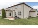 Backyard features a well-maintained lawn, patio with grill, and beige siding with a brown roof at 7730 Imperial Eagle Dr, Zionsville, IN 46077