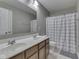 Bathroom featuring a double vanity, large mirror, and shower-tub combination at 7730 Imperial Eagle Dr, Zionsville, IN 46077