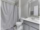 Neutral bathroom with a shower, tiled wall, and a single sink vanity with gray cabinetry at 7730 Imperial Eagle Dr, Zionsville, IN 46077