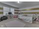 Cozy bedroom featuring a playful striped wall design, a study area, and a comfortable daybed at 7730 Imperial Eagle Dr, Zionsville, IN 46077