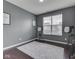 Spare bedroom with gray walls, minimal furniture, hardwood floors, and a natural light at 7730 Imperial Eagle Dr, Zionsville, IN 46077