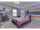 Bright bedroom featuring colorful walls, a patterned quilt, and a dedicated desk area at 7730 Imperial Eagle Dr, Zionsville, IN 46077