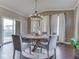 Bright dining room featuring modern lighting, a dining table, and a sliding door at 7730 Imperial Eagle Dr, Zionsville, IN 46077