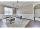 Bright dining area featuring wainscoting, two benches, hardwood floors, and modern lighting at 7730 Imperial Eagle Dr, Zionsville, IN 46077