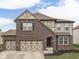 Charming two-story home featuring a brick facade, arched entryway, and a spacious two-car garage at 7730 Imperial Eagle Dr, Zionsville, IN 46077