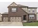 Charming home showcasing an attached two car garage, arched entry, and nicely landscaped yard at 7730 Imperial Eagle Dr, Zionsville, IN 46077