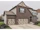 View of a well maintained home with an attached two car garage and manicured lawn at 7730 Imperial Eagle Dr, Zionsville, IN 46077
