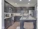 Bright kitchen featuring stainless steel appliances, dark cabinets, granite counters, and a central island at 7730 Imperial Eagle Dr, Zionsville, IN 46077