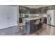 Modern kitchen with stainless steel appliances, a center island with counter seating, and dark wood cabinets at 7730 Imperial Eagle Dr, Zionsville, IN 46077