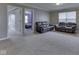 Spacious living room with carpet, dark leather seating, and view into spare bedroom at 7730 Imperial Eagle Dr, Zionsville, IN 46077