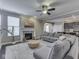 Cozy living room featuring a fireplace, large sectional sofa, and a ceiling fan at 7730 Imperial Eagle Dr, Zionsville, IN 46077