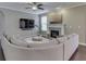 Cozy living room featuring a fireplace, large sectional sofa, and a ceiling fan at 7730 Imperial Eagle Dr, Zionsville, IN 46077