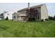 Spacious backyard with lush green grass, patio, and mature trees perfect for outdoor activities at 8358 Balmoral Dr, Avon, IN 46123
