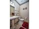 Classic bathroom featuring a pedestal sink, decorative wallpaper, and neutral tile flooring at 8358 Balmoral Dr, Avon, IN 46123