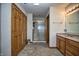 Bathroom featuring walk-in shower, neutral tile, and spacious vanity at 8358 Balmoral Dr, Avon, IN 46123