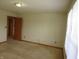 Neutral bedroom with carpeted floors and a view of two entry doors at 8358 Balmoral Dr, Avon, IN 46123