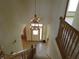 Grand foyer view from the top of the stairs with a chandelier and tile flooring at 8358 Balmoral Dr, Avon, IN 46123