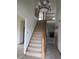 Inviting foyer with a staircase, chandelier and views of the living room with fireplace at 8358 Balmoral Dr, Avon, IN 46123