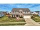 Charming two-story home featuring a brick facade, attached garage, and well-maintained lawn at 8358 Balmoral Dr, Avon, IN 46123
