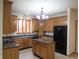 Well-equipped kitchen with wooden cabinetry, island, and modern appliances, ideal for cooking at 8358 Balmoral Dr, Avon, IN 46123