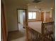 Carpeted landing area with a doorway view to the naturally lit bedroom at 8358 Balmoral Dr, Avon, IN 46123