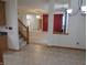 Open-concept living room with neutral paint colors, carpeted floors, and a staircase at 8358 Balmoral Dr, Avon, IN 46123