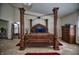 Spacious primary bedroom featuring a four poster bed and bright natural light at 8358 Balmoral Dr, Avon, IN 46123