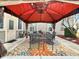 Cozy covered patio with decorative rug, string lights, fan and outdoor seating perfect for entertaining at 8358 Balmoral Dr, Avon, IN 46123
