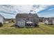 A lovely rear view of a home with a pergola and sunroom, surrounded by a large, green lawn at 8358 Balmoral Dr, Avon, IN 46123