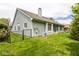 Well-maintained backyard with lush lawn, privacy fence, and views of the home's architectural features at 8737 Champions Dr, Indianapolis, IN 46256