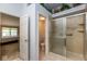Bathroom featuring a glass shower, tile flooring, and stylish decor, offering a clean and functional space at 8737 Champions Dr, Indianapolis, IN 46256
