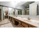 Spacious bathroom with double sinks, large mirrors, a tiled floor, and a glass-enclosed shower, offering modern amenities at 8737 Champions Dr, Indianapolis, IN 46256