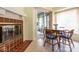 Cozy breakfast nook featuring a fireplace, tile flooring, a round wooden table, and a sliding door to the patio at 8737 Champions Dr, Indianapolis, IN 46256