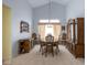 Formal dining area with high ceilings, elegant chandelier, and wooden furniture set against light blue walls at 8737 Champions Dr, Indianapolis, IN 46256