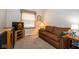 Cozy living room with a brown sofa set and natural light from a window with wooden blinds at 8737 Champions Dr, Indianapolis, IN 46256