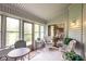 Inviting sunroom with plenty of windows, a variety of seating, and views of the yard, perfect for relaxation at 8737 Champions Dr, Indianapolis, IN 46256