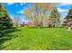 Expansive green lawn and mature trees under a blue sky at 901 W 250 N, Lebanon, IN 46052