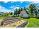 Backyard area featuring raised garden beds and a shed at 901 W 250 N, Lebanon, IN 46052