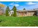 Spacious backyard with manicured lawn, pergola, and lush greenery at 901 W 250 N, Lebanon, IN 46052
