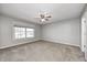 Neutral primary bedroom with a ceiling fan and natural light from the large window at 901 W 250 N, Lebanon, IN 46052