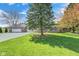 Charming brick home with a well-manicured lawn, mature trees, and a spacious driveway leading to an attached garage at 901 W 250 N, Lebanon, IN 46052