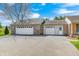 Three-car garage and entrance with brick and white door at 901 W 250 N, Lebanon, IN 46052